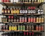 Thumnbail of BBQ sauces and hot sauces on shelves in store at Outdoor Living in Collierville, Memphis TN