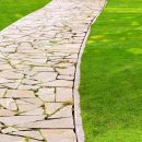 Flagstone paver stones creating path on lawn